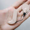Cochlear implant being held in a hand