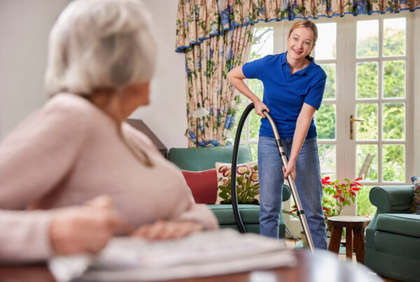 Young worker vacuuming in aged care